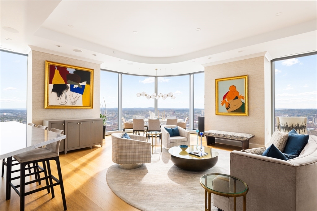 Rising above Back Bay on the 48th floor of One Dalton—Boston’s tallest residential tower—Residence 4804 captures breathtaking, unobstructed views at every turn. Spanning over 2,500 square feet, this customized 3 bedroom, 3.5 bath home is framed by soaring floor-to-ceiling glass with sweeping views of the Charles River, Boston Harbor, and Fenway Park. The sun-filled great room offers generous living and dining areas that flow seamlessly into a beautifully appointed kitchen. Two bedroom suites are thoughtfully tucked away from the main living spaces, and a flexible third room—ideal as a bedroom, den, or home office—is complemented by an additional full bath. A powder room and dedicated laundry room complete the layout. Two valet parking spaces included. Residents enjoy the full suite of Four Seasons services: 24-hour concierge and doorman, world-class fine dining, state-of-the-art fitness center, 65-foot indoor lap pool, signature spa, and a private residents-only club lounge.
