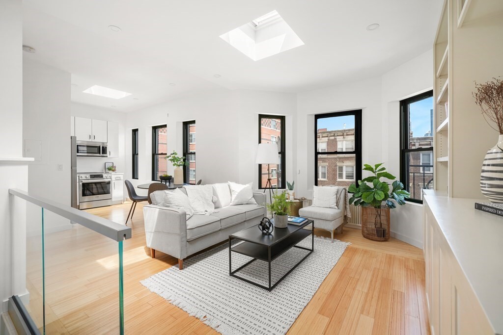 Welcome to the Duplex on Jersey, a rare renovated penthouse duplex in prime Fenway offering 2 beds, 2 full baths, skyline views, and income in place through 8/31/2027 at $4,950 per month. The two-level layout creates separation for guests, work, or shared living. The chef-caliber kitchen features custom cabinetry and a Bosch stove. Refinished bamboo hardwood floors, new windows with Back Bay views, and dimmable LED lighting set an elevated tone throughout. Four skylights keep the space sun-filled by day. Both bathrooms are fully updated with glass-enclosed showers. In-unit laundry, a walk-in closet, and HOA-included heat and hot water add everyday ease. Boylston Street is right at your doorstep with cafes, groceries, and dining within reach. With the lease ending ahead of the fall cycle, this turnkey Fenway home offers flexibility for future occupancy or investment in a professionally managed building near Longwood, universities, transit, and neighborhood amenities. Reach out today for a private tour.