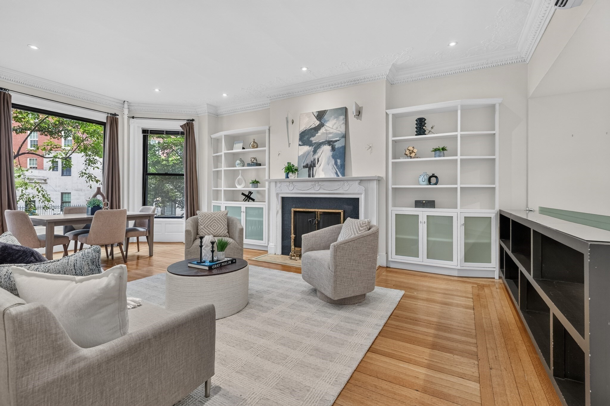Occupying the length of the parlor & garden levels, this duplex provides all the amenities you need to enjoy city life- including TWO full direct access parking spaces. The unit's renovation compliments the parlor level's periodic details... impressive 10 ft ceiling height, ornate crown moldings, & 3 grand fireplaces. A lovely front-facing living room with bay window, built-ins & fireplace flows into the centerpiece kitchen...fully equipped with a center island, Poggenpohl cabinetry, Miele double oven, Wolf 5-burner gas cooktop, new Bosch dishwasher, Sub-Zero fridge & 2nd fireplace.. Pocket doors lead to an expansive rear-facing bedroom with en-suite bath, fireplace & river views.  The primary retreat resides on the garden level- complete with radiant heated floors, walk-in closet with laundry & en-suite bath with rainfall shower and Duravit air tub. A bonus room offers a flex space for office or nursery. Unit controlled A/C & 2 assigned storage closets add to the home's features.