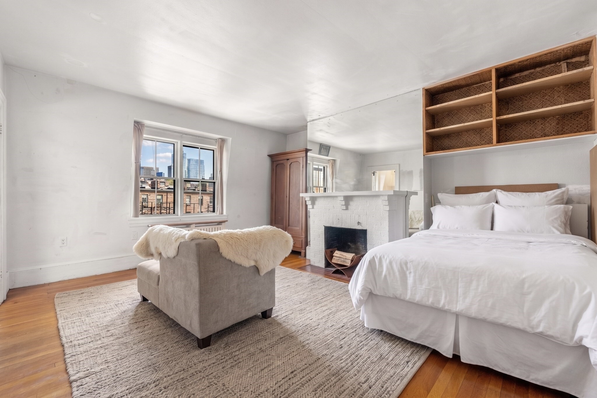Sitting on the Flat of Beacon Hill, this penthouse studio on Brimmer Street delivers the full romance of the neighborhood from an elevated vantage point. Moments from the city's best restaurants, boutique shopping, and the Esplanade, the location couldn't be better. A wood-burning fireplace with brick surround anchors the living space, while city views stretch beyond the rooftops. The kitchen opens to a skylight and generous window that flood the room with natural light. The tiled bathroom offers a tub/shower combo and thoughtful built-in storage, making every inch count. For investors or buyers seeking a starting point in one of Boston's most coveted neighborhoods, this one is hard to beat.
