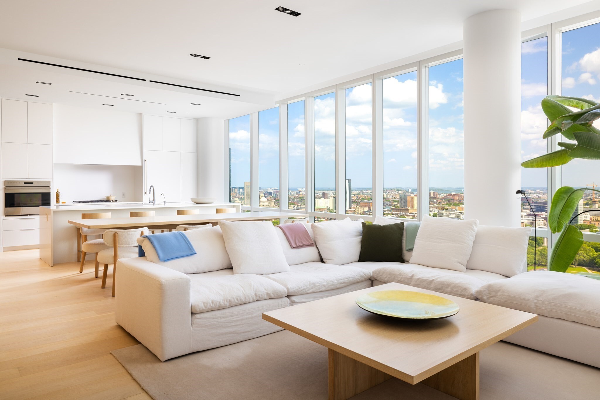 Perched on the 29th floor—the penthouse level of The Pierce—this extraordinary 2-bedroom, 2.5-bathroom residence sets a new standard for city living in Boston's vibrant Fenway neighborhood. Floor-to-ceiling windows frame breathtaking, unobstructed views stretching across the city skyline and Boston Harbor, flooding every room with natural light from sunrise to sunset. The seamless flow between the living, dining, and kitchen areas enhances the home's remarkable sense of space and light. The primary suite is a true sanctuary, complete with a generous dressing room and a spa-inspired en-suite bath. The second bedroom includes a full bath and easily functions as a private den or dedicated home office. Tucked behind custom built-in cabinetry, a cleverly concealed laundry room adds both function and style. Residents enjoy 24-hour concierge, a fitness center, pool, and lounge. 2 garage parking spaces complete this exceptional offering.