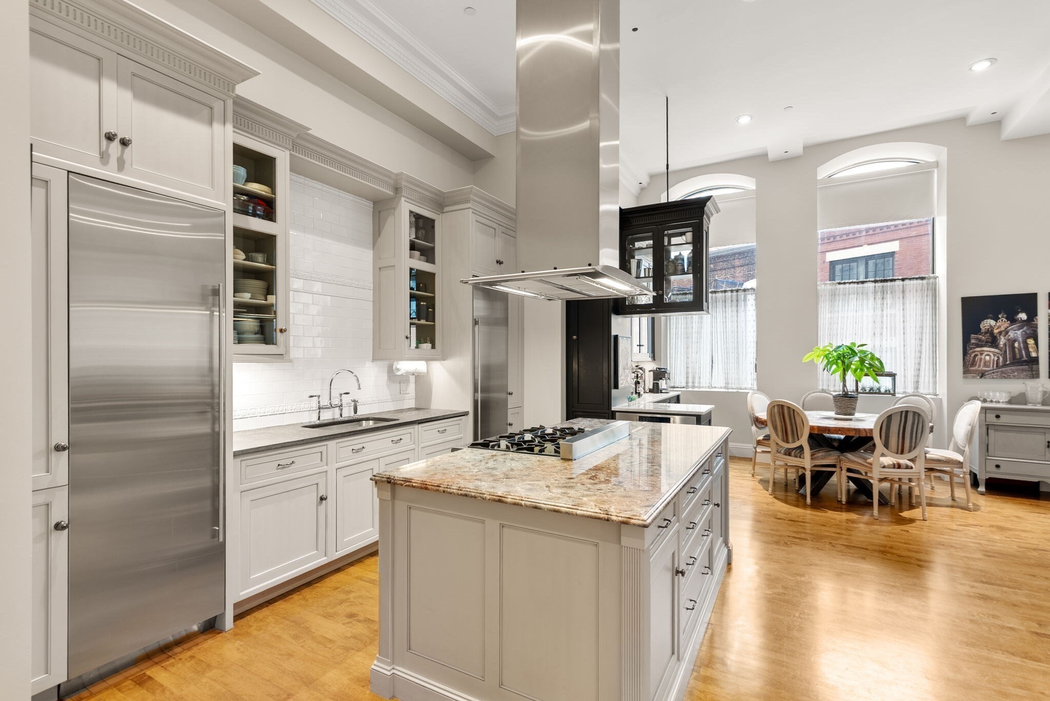 Elevate your urban living experience within this meticulously maintained luxury condominium at The Albert Pope Building. Straddling the border between South End and Back Bay and sharing an address with legendary Mistral Restaurant, this location is unbeatable. The expansive 1,517 SF features high windows & ceilings and tasteful updates throughout that exude excellence. The open-plan kitchen, seamlessly integrated with the living room, is a culinary enthusiast's dream. It features high-end cabinets and chef's appliances all centered around a functional island and complimented by the adjacent dry bar with extra storage. The fully renovated primary bathroom is distinguished by a luxurious soaking tub and new glass shower enclosure, while another provides a walk-in shower equipped with multiple showerheads. If you are looking for some fresh air, enjoy a glass of wine or BBQ with friends while taking in the sweeping city views from the rooftop deck.