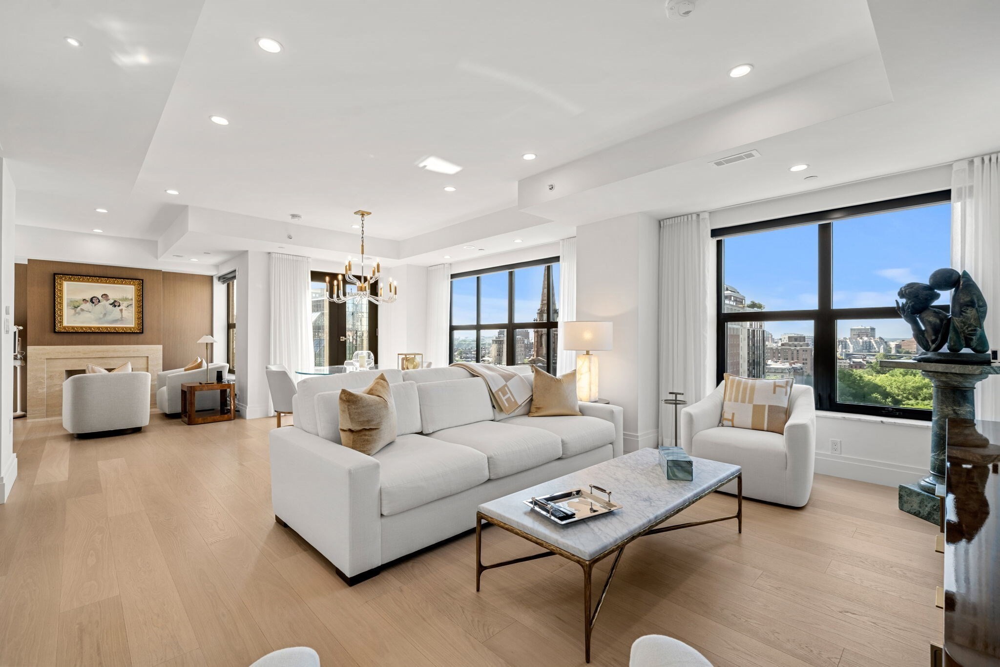 Experience unobstructed views of the Boston Public Garden from this exceptional corner penthouse at The Heritage on the Garden, where the iconic Swan Boats glide peacefully below.Spanning 2,492 square feet, this meticulously reimagined residence offers two bedrooms with a study ,two full bathrooms, and one half bath. Completely renovated  and completed in late 2023, every finish, fixture, and system is brand new, creating a home that seamlessly blends timeless elegance with modern luxury.The expansive living room is filled with natural light, centered around a beautiful fireplace, and opens to a private balcony overlooking the Public Garden. A separate study, spacious walk-in laundry room, and dedicated shoe closet add both functionality and sophistication.The chef's kitchen showcases custom cabinetry, marble countertops, premium professional-grade appliances, and custom Italian hardwood flooring that extends throughout the residence.The luxurious primary suite features its own private terrace, an extraordinary dressing room, a second custom-lit walk-in closet, and a spa-inspired marble bath with dual vanities and designer fixtures. The secondary bedroom also enjoys an en-suite marble bath finished to the same exceptional standard. Residents of The Heritage on the Garden enjoy white-glove amenities including a 24-hour doorman and concierge, valet service, on-site management, library and tea room, fitness center, and deeded garage parking. A rare opportunity to own a completely reimagined penthouse in one of Back Bay's most prestigious full-service residences, overlooking Boston's most iconic park.