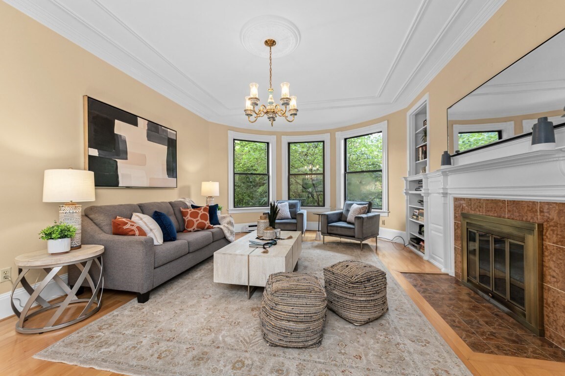 Enjoy living on the sunny side of the street! This bright 2-bedroom, 1-bath home comes with a private deeded parking space on one of Back Bay's most beautiful streets. With nearly 1,000 sf, it pairs classic architectural character with everyday city convenience.Walk up the elegant grand staircase or take the elevator to your new home! The open living/dining area features a decorative fireplace, built-in bookshelves, gleaming hardwood floors, and large windows that flood the home with natural light. Pass through the architectural archway to the spacious dining room perfect for entertaining or a quiet dinner at home.The primary bedroom features a second decorative fireplace and a walk-in closet. Best of all, the large second bedroom works beautifully as a bedroom or a home office. The kitchen and bath are ready for your personal touch to make them your own!  At the end of the day, take the elevator up to the common roof deck for spectacular city views! Other features include central A/C, a private storage unit, and direct access to your parking space. With a Walk Score of 96 (Walker's Paradise), Transit Score of 88, and Bike Score of 90, you're close to the incredible restaurants and shops of Back Bay as well as the Charles River Esplanade.Don't miss your chance to own a piece of one of Boston's most iconic and beloved neighborhoods. Come see it for yourself!