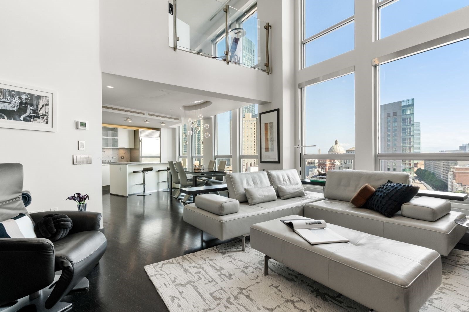 Discover an exceptional urban oasis where no detail has been overlooked. This spectacular penthouse is being offered on the market for the first time since the property was redeveloped. Spanning two stories, the residence features floor-to-ceiling windows with panoramic views of Boston. An open-concept layout seamlessly connects the living, dining, and kitchen spaces, creating an ideal setting for both everyday living and sophisticated entertaining. The kitchen features granite countertops, stainless steel appliances, and a large island. Enjoy high-end surround sound, luxury furnishings, Bang & Olufsen audio, and a retractable projector, perfect for movie nights and sporting events. Upstairs, a spacious bedroom overlooks the lower level, creating a private retreat within this expansive condominium. The suite features a walk-in closet and a spa-like en-suite bathroom. Additional features include central heating and cooling, in-unit laundry, an oversized hot water heater, and private storage. 360 Newbury is a pet-friendly, 24-hour concierge building in a premier Back Bay location, just moments from high-end shopping, fine dining, public transportation, and world-class universities and cultural institutions. Rental parking is available nearby at several garages.