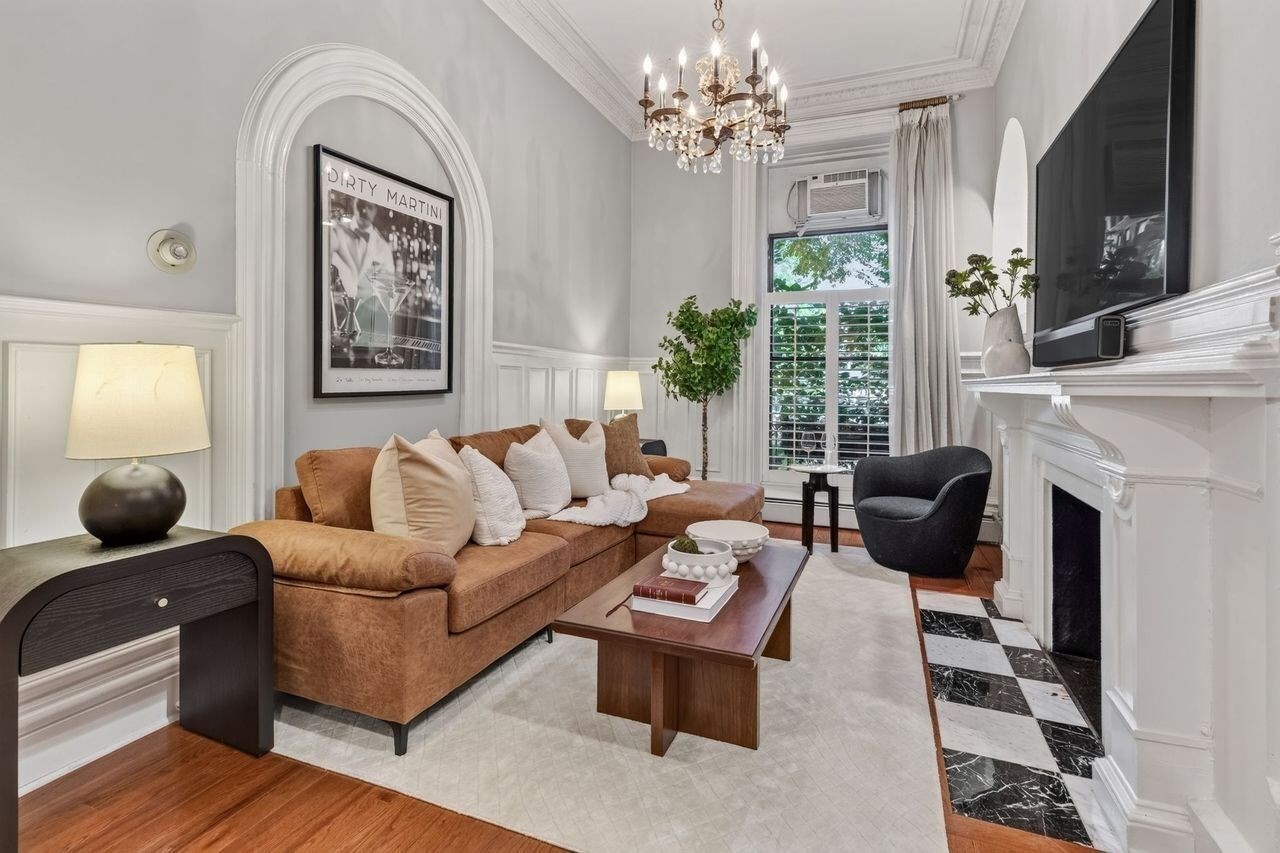Located in the heart of Back Bay on the cusp of Beacon Hill, this front-facing parlor unit sits perfectly on Beacon Street between Arlington and Berkeley, directly across from the Arthur Fiedler Footbridge with easy access to Storrow Drive, I-93, and the Mass Pike.High ceilings and hardwood floors set the tone in the living room, anchored by a fireplace flanked with arched, mirrored built-ins and brightened by a quaint Juliet balcony. Beautiful millwork, plantation shutters and original exposed brick walls completes the space. The white shaker kitchen features a subway tile backsplash, stainless appliances, granite counters, and black-and-white marble flooring, opening to a separate dining area. A spiral staircase leads to additional living space consisting of a spacious full bath, den, and generously sized bedroom, with a walk-in custom closet and coat closet offering plenty of storage. The renovated bathroom impresses with a large glass-enclosed walk-in shower with two shower heads finished in Carrara marble subway tile, a modern wall-mounted toilet and a generous sized vanity with mirror. Additional highlights include a common area patio, common free laundry and new common building boiler.With Newbury Street, the Charles River, Beacon Hill, and the Boston Public Garden all just minutes away, this condo offers a truly central, unbeatable location.