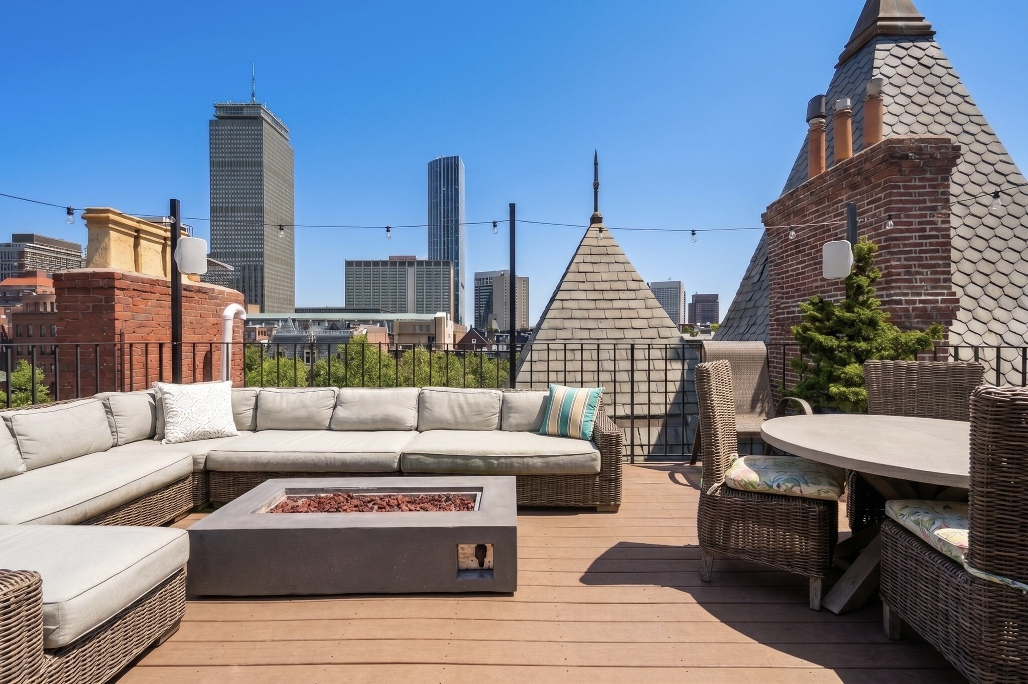 On the sunny side of Commonwealth in a luxury building the bright and airy living/entertaining areas flow beautifully in an effortless open layout! Lofty ceilings contribute to the wonderful sense of space in a triple wide building. The home has expansive windows to take in the breathtaking Back Bay views. Wonderful layout grounded by stained hardwood floors. Framed in statuary marble the wood burning fireplace creates for focal point for gathering and living room space flowing into dining area with amazing natural light from the skylight above. The kitchen is beautifully outfitted with custom cabinetry, Dornbracht fixtures and Sub-zero appliances. Spacious Primary Bedroom with walk-in closet and exquisite spa-like primary bathroom with skylight, glass shower and Victoria & Albert soaking Tub. The plus room has a skylight and is perfect as an office or play room. Upstairs you can find a private roof deck with gas line hookup (fire-pit ready) and grill, perfect for entertaining. One parking spot included and an additional spot available for purchase.