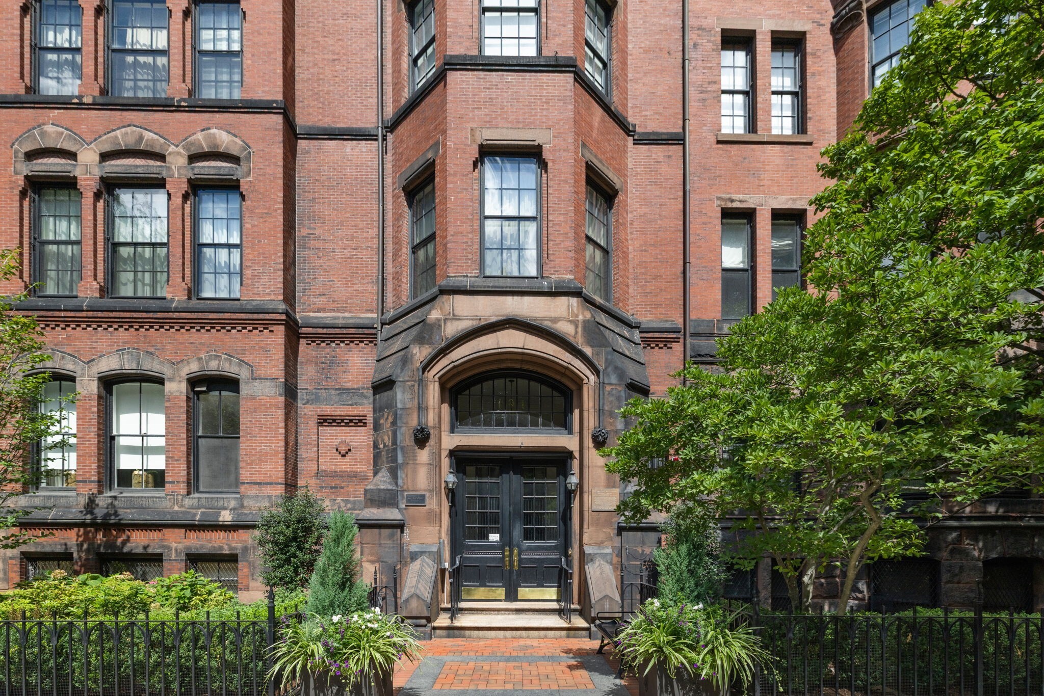 Gracious south-facing Back Bay penthouse in the historic Hotel Agassiz, an 1872 Gothic Revival landmark by Weston and Reed, one of Back Bay's first "French Flats" buildings. Enter via a marble octagonal lobby with door attendant service to this meticulously restored, sun-filled 4,072 square foot, 3-plus-bedroom, 3.5 bathroom residence. A grand, skylit foyer with white oak floors and fine millwork leads to a formal dining room and family room with marble fireplace, custom built-ins, and Commonwealth Ave Mall views. The chef's kitchen boasts a 10' marble island, custom cabinetry, Sub-Zero refrigerator, pantry, and dedicated wine cooler. A sun-splashed sitting room, study with marble fireplace, and guest bedroom suite complete one wing; a primary suite with walk-in closet and marble en-suite bath, plus a second en-suite bedroom, anchor the private quarters. Central AC, ground-floor storage, and bike storage included. Steps to Newbury Street and the Esplanade.