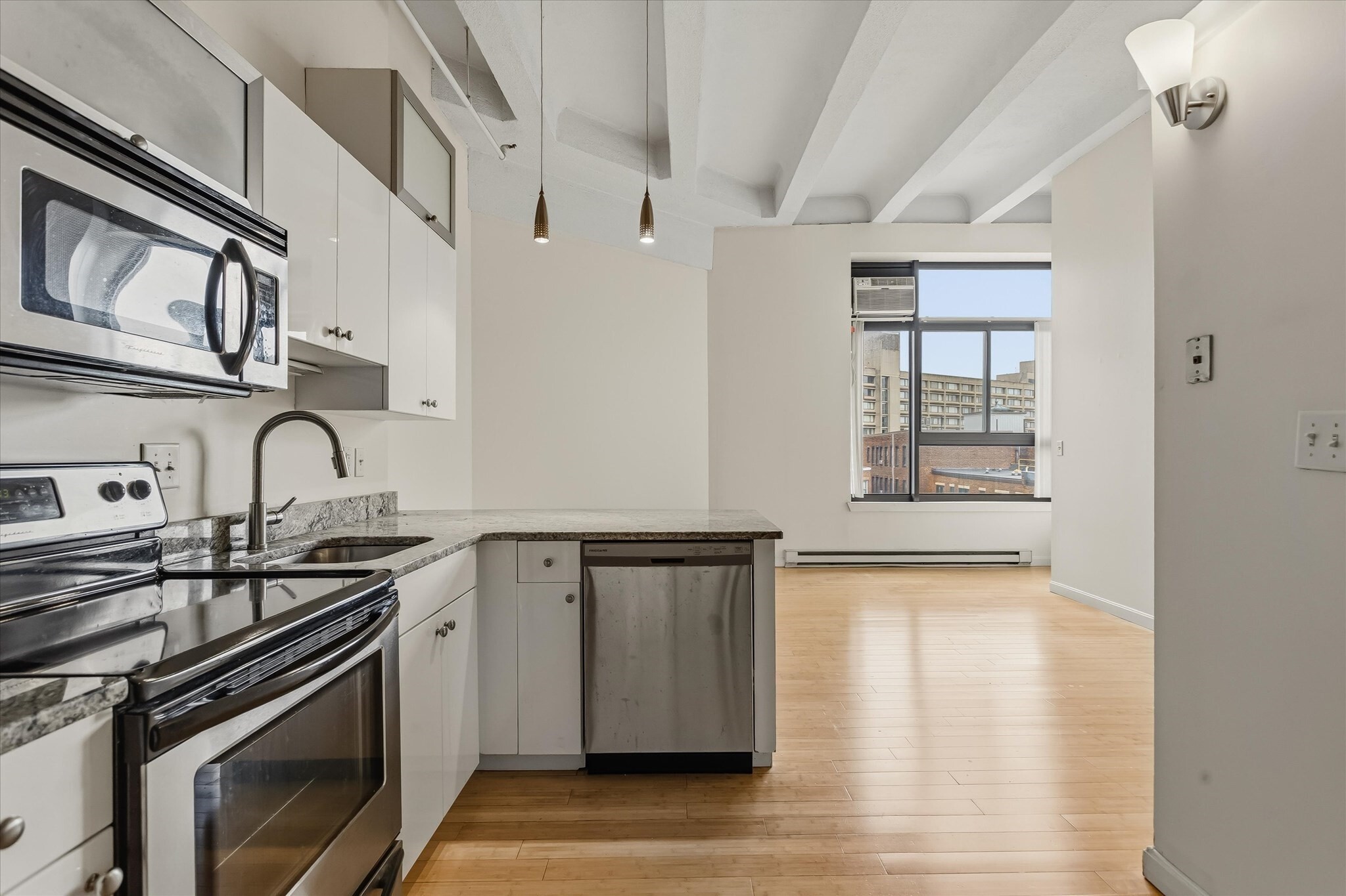 Your luxury lifestyle awaits! The Loft Condominium at XII Stoneholm offers a boutique elevator building experience complete with a fabulous outdoor rooftop pool and multiple decks featuring panoramic cityscape views! A terrific on site Fitness Center, Concierge and bike room completes this city oasis. This open concept loft-style residence is sun splashed with 11' ceilings, wall A/C, hardwood flooring and several loft spaces offering stunning skyline views of Boston. The designer kitchen features custom cabinetry,  granite countertops with breakfast bar and stainless steel appliances. Moments to Fenway Park and the posh boutiques on Newbury Street as well as numerous quaint restaurants and shops in the nearby Symphony enclave. For dining in, Whole Foods is located just around the corner. Easy access to multiple universities such as Northeastern, BU and Berklee School of Music as well as to  I-90, I-93 and the MBTA. Moments to CarGurus, Whoop and many local startup businesses. Rental parking available in on-site garage for an additional fee, when available.  A perfect investment opportunity or Pied-A-Terre!