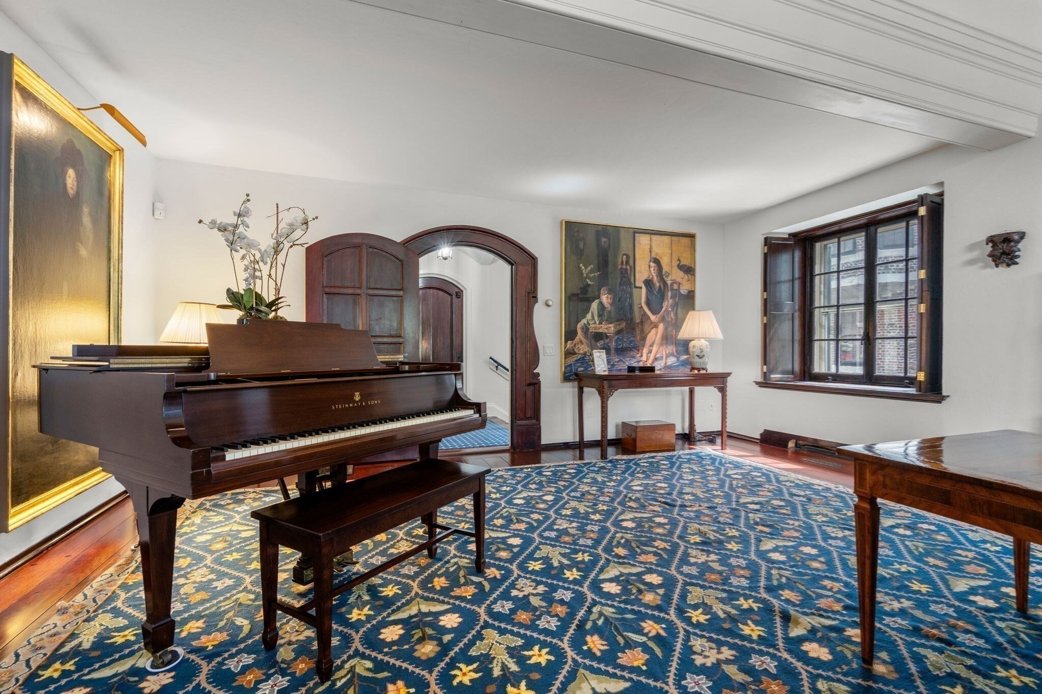 Tucked away on a private cul-de-sac in Beacon Hill, this magnificent corner residence at West Hill Place offers a rare combination of privacy, scale, and convenience, complete with a direct parking space at your front door. Spanning over 6,100 square feet, this exceptional home features 6 bedrooms, 5 full baths, and 2 half baths, blending historic character with thoughtful modern living. Bathed in natural light from exposures on three sides, the home is designed for both grand entertaining and comfortable everyday living. A dramatic two-story great room with soaring beamed ceilings serves as the centerpiece of the home, while a formal dining room overlooks the space from above. The spacious eat-in kitchen is appointed with premium appliances, Downsview custom cabinetry, abundant storage, and generous Black Walnut counter space. A handsome library with a wet bar provides an inviting retreat, and six fireplaces throughout add warmth and timeless charm.The expansive primary suite features South & West exposures, a walk-in closet, and a beautifully appointed en-suite bath. Five additional generously sized bedrooms, including including a private lower-level au pair suite complete with a kitchenette and full bath, offer exceptional flexibility for family, guests, or home office needs. Crowning the residence is a spectacular private roof deck showcasing sweeping views of the Charles River, Cambridge, and the Boston skyline, creating an extraordinary setting for outdoor entertaining and relaxation. Ideally located just moments from the Public Garden and the renowned shops, cafés, and restaurants of Charles Street, this rare offering presents an unparalleled opportunity to experience Beacon Hill living at its finest.