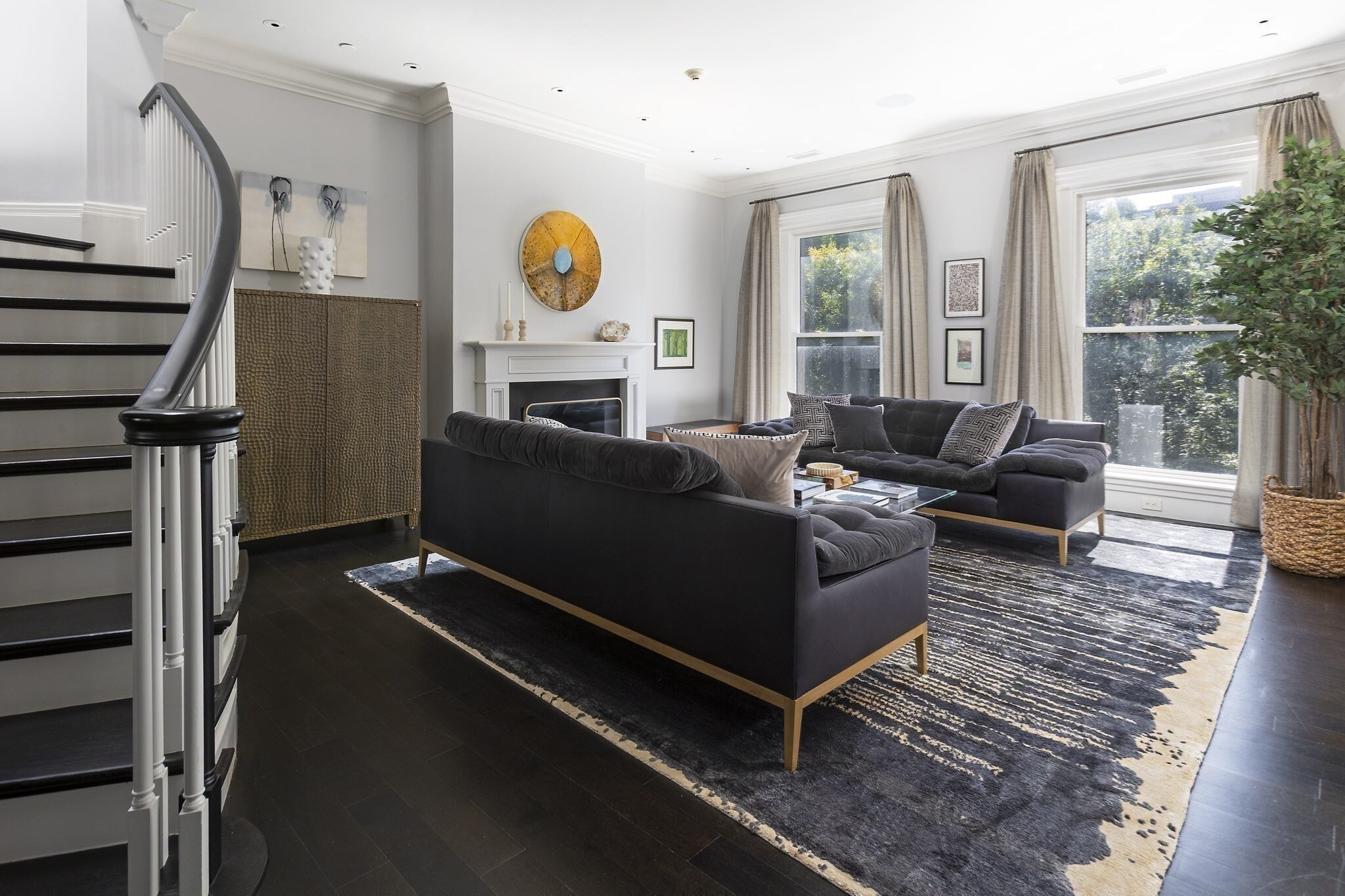 Exquisite penthouse duplex on the first block of Commonwealth Ave! This owner occupied, professionally managed building is comprised of 3 units and offers secure direct elevator access, private storage closet, and on-site garage parking. Welcomed into the main living level of this gracious penthouse by a magnificent staircase, you are immediately drawn into the formal living room with its large Comm Ave facing windows, beautiful fireplace and attached private office with its own fireplace, built-ins and Comm Ave views. A formal dining room is adjacent to an open family room and kitchen that offers direct access to a private deck. A well designed kitchen with abundant storage, gas cooking, 3 ovens, top-of-the-line appliances and an island with breakfast bar. The kitchen also has access to a back hall w wine storage and second staircase, as well as the powder room and front hall closet. An elegant skylit staircase floods the home with natural light and leads to the upper level of the home. 3 generous bedrooms including a large front facing primary suite with fireplace, 5-piece stone bathroom and attached dressing room. 2 additional bedroom share a beautiful stone bathroom. A full staircase and head house with wet bar open to a sensational and large roof deck! Ideal for entertaining, this urban oasis has water, electricity and sensational views over the Comm Ave Mall. This gracious home also offers a 4 gas fireplaces, storage, a laundry room, central air, and many built-ins throughout. Complete with captivating views of the Back Bay skyline and Comm Ave Mall, this fabulous penthouse has it all including on site garage parking for 4 cars!