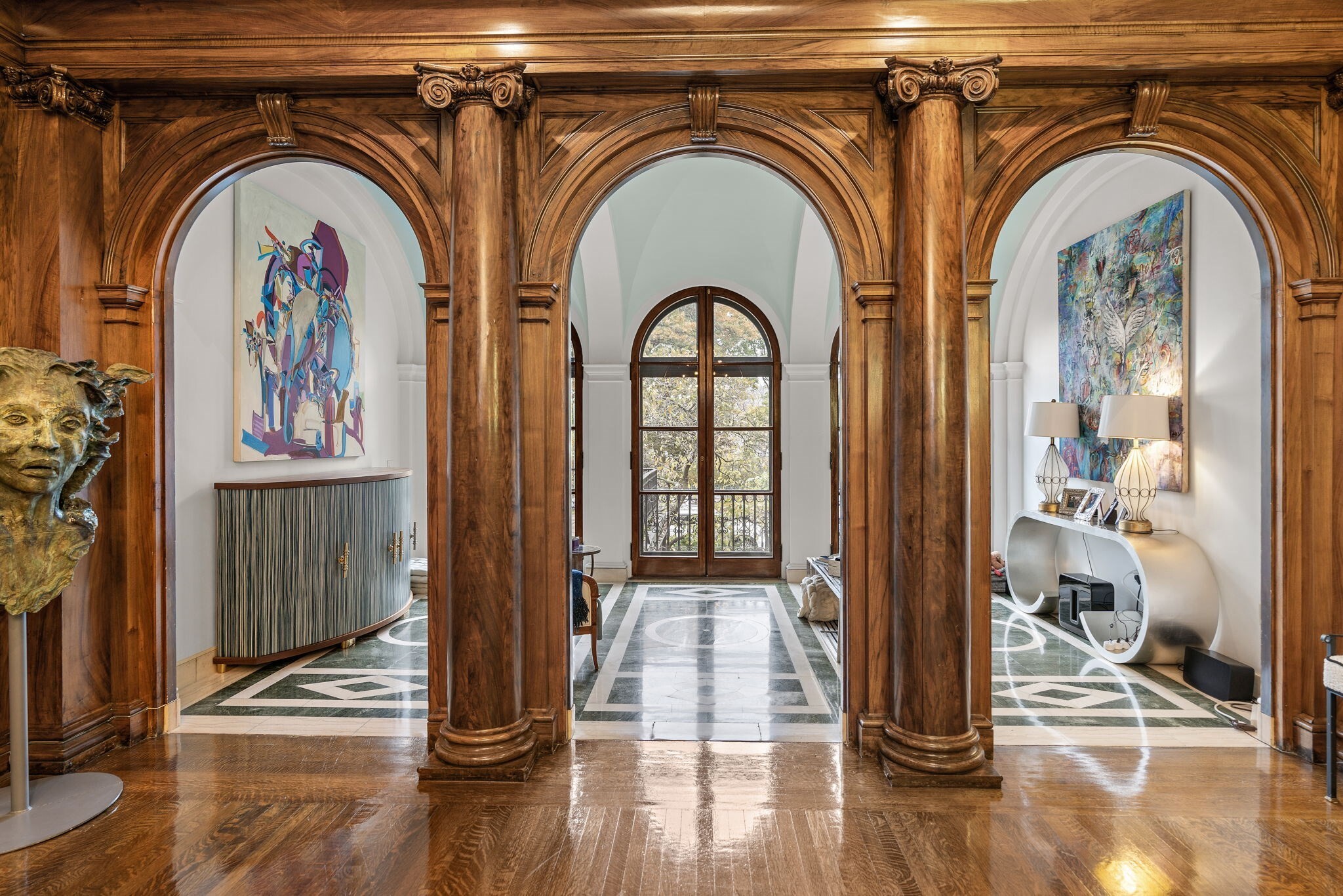 A full-floor Back Bay residence with a private terrace, Charles River views, direct elevator access, and one deeded parking space. Set within a Peabody & Stearns-designed brownstone, this approximately 2,600-square-foot home pairs richly detailed interiors with a renovated kitchen and two bedrooms, each with its own full en-suite bath. Intricate woodwork, arched openings, high ceilings, and three ornate fireplaces distinguish the living and entertaining spaces. The kitchen features a La Cornue range, Italian porcelain countertops, and custom cabinetry. The marble-clad primary bath includes a double walk-in shower, while a separate half bath serves guests. Central air and in-unit laundry add everyday convenience. Enjoy private outdoor space and a Back Bay setting close to the Esplanade, Newbury Street, and Copley Square.