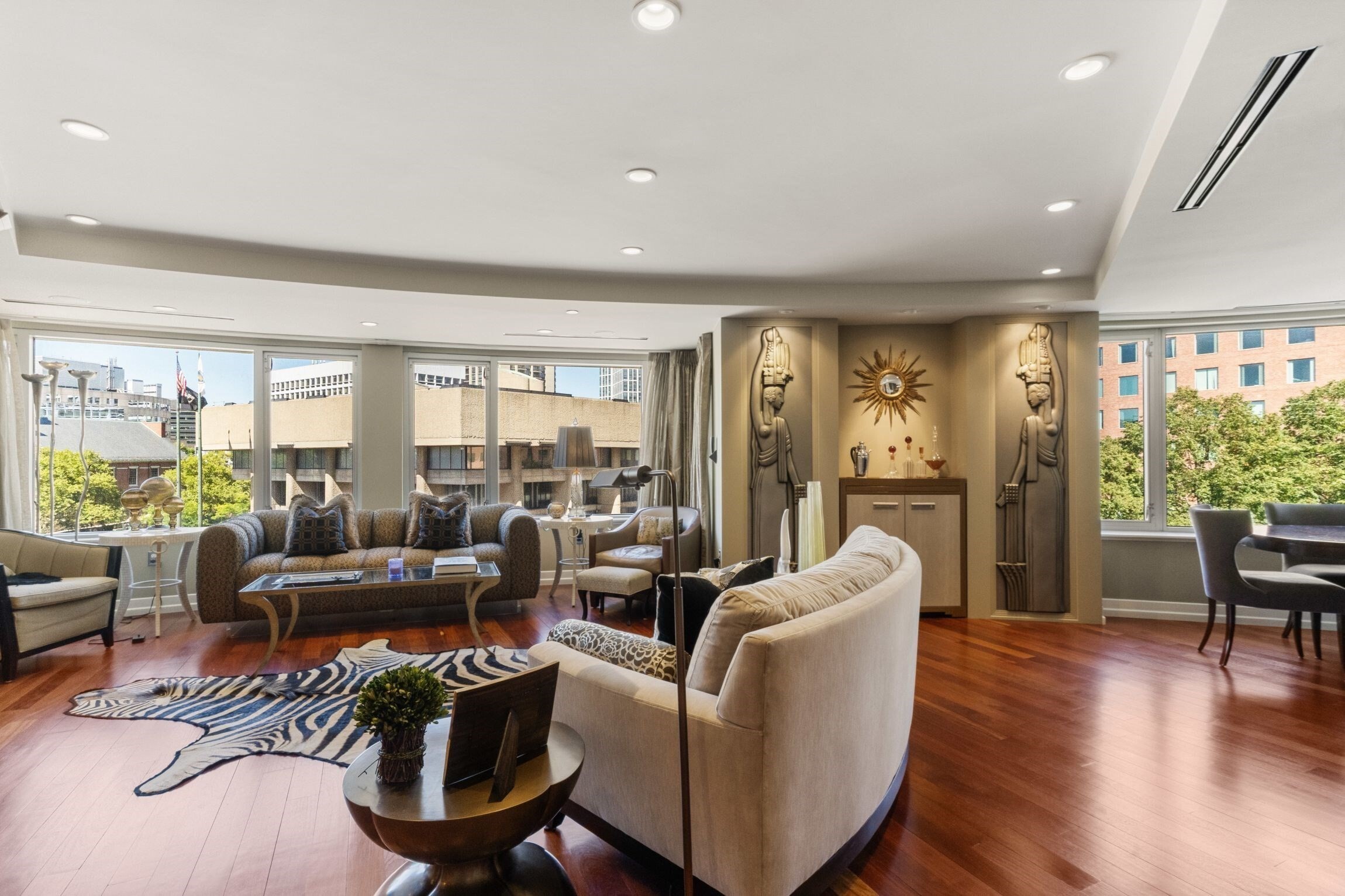 This Beacon Hill three bedroom home has been exquisitely redesigned by Duncan Hughes Interiors into an Art Deco masterpiece with the ideal floor plan. Formal entry foyer with custom marble in-lay, stunning silk panels and integrated over-sized coat closet.  The entertainer’s living space features panoramic tree top views, formal dining and a chef’s kitchen by Venegas Kitchens; gorgeous custom cabinetry with patina’d copper inlay, integrated Subzero, Miele and JennAir appliances with storage at every turn. Bar nook with shagreen serving cabinet. Exceptionally crafted living room built-in houses a plasma flatscreen, beverage drawers and wine cabinet. Layered drapery frames the over-sized windows that wrap the living space. Adjacent hallway powder room. Serene and spacious primary suite with custom wall to wall silk/wool rug and spa like Calacatta marble bath featuring double vanity, soaking tub, walk-in shower, heated floors and fixtures by Waterworks.  Guest suite/2nd bedroom features ensuite bath with Waterworks vanity with Thassos marble top and walk in shower. Third bedroom/plus is currently being used as an office but could easily function as a third bedroom/nursery. Mahogany wood flooring, built in sound and lighting system, in unit washer/dryer and A/C.  All this and an over-sized deeded storage unit and direct access to TWO side by side garage parking spaces. Ideally located minutes to Whole Foods, downtown and the best of Beacon Hills restaurants and shops.