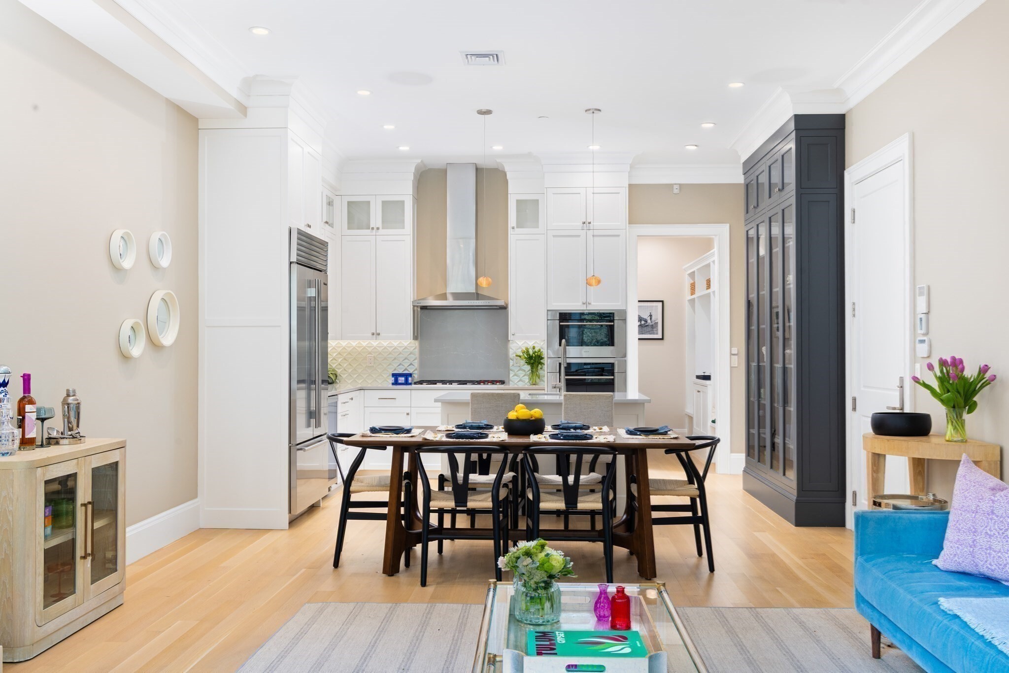 Set on the parlor and garden levels of an unusually wide South End/Back Bay building, this 2019 gut-renovated three-bedroom plus office duplex lives like a single family. The generous parlor has a bay of oversized windows that flood the main living space with light all day long. The huge chef's kitchen has a rare adjacent pantry which houses a floor to ceiling Sub-Zero wine fridge, extra beverage drawers and suburban like storage for dry goods.  The living room boasts a warm gas fireplace and is an entertainer's dream with enough space for all of your friends and neighbors.  The kitchen anchors it all: Sub-Zero and Wolf gas appliances, stone counters, custom cabinetry and a convenient island for morning coffee -  the kind of setup that makes hosting effortless, whether it's a dinner party for twelve or a quiet Sunday morning. Hardwood floors run throughout, tying the whole home together. The bedroom level has three true bedrooms, a dedicated office/gym space, a full laundry room and extra storage. Location-wise, you get the best of both worlds. You're close enough to the Pru, Newbury Street, and Copley Square to walk to the Back Bay, but step outside and you're immediately in South End  — brownstone-lined streets, a slower pace, neighbors who actually know each other. The restaurants, galleries, and sidewalk energy that make the South End special are just steps from your door. A short hop to Titus Sparrow park for green space, playgrounds and outdoor bands in the summer make this the ideal local spot to enjoy all that the South End has to offer.
