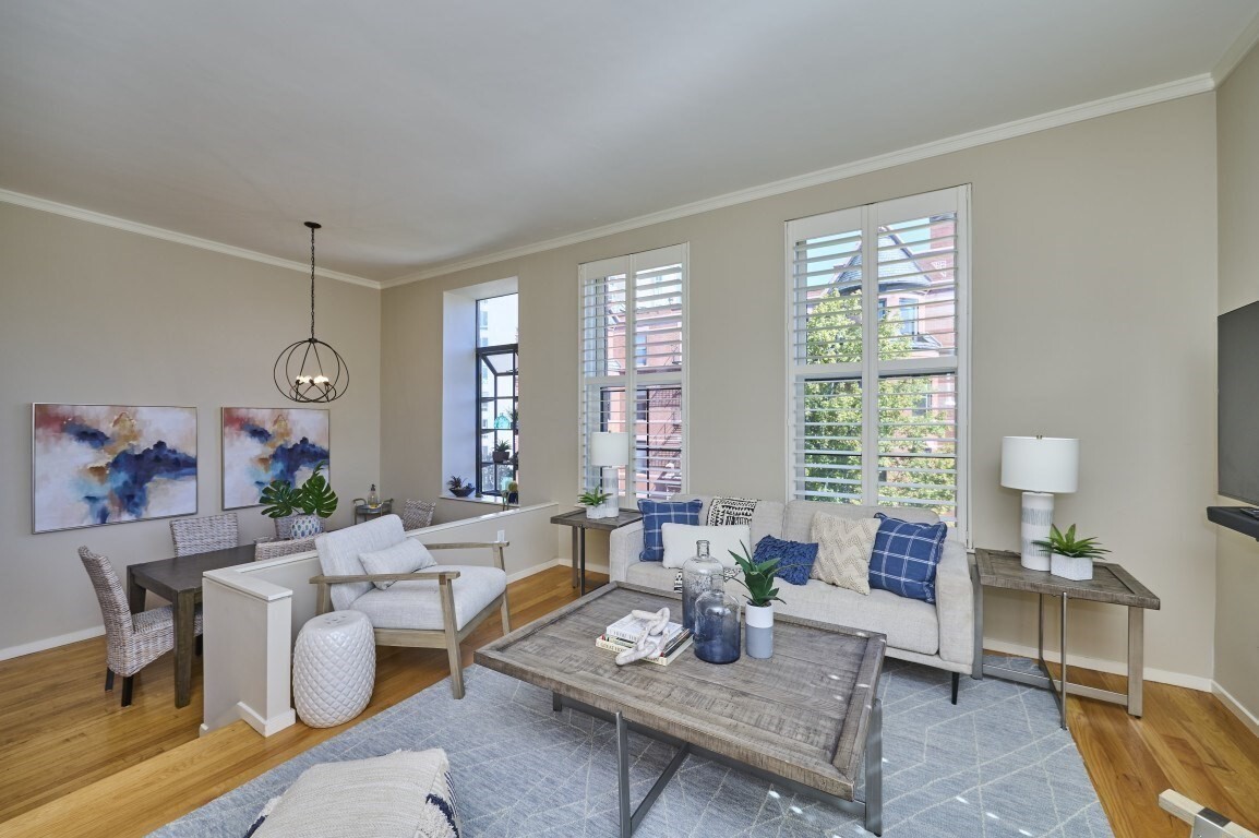 Beautiful two-bedroom with built-in library/study!  Enjoy the room to live, work, entertain, and truly settle in, all in the heart of Back Bay. Unit 24 at the School House Condominium offers a thoughtfully designed two-level layout, giving you the kind of flexibility and separation that is hard to find in a city condo. Step inside and discover a warm, inviting home where beautiful wood floors, high ceilings, and custom built-ins bring character to every level. The living room offers generous space to relax and gather, with custom shelving and cabinetry providing both style and functionality. Just beyond, the dining room welcomes everything from quiet dinners to evenings with friends, framed by a charming bay window that adds natural light and architectural character. The kitchen keeps everyday cooking practical and connected to the rest of the home, with stainless steel appliances ready for everything from morning coffee to dinner. When it's time to unwind, retreat to one of two comfortable bedrooms, both featuring wood flooring and thoughtful storage. The second bedroom also offers a built-in desk and high ceilings, creating an ideal space for a home office, guest room, or personal retreat. And then there is the library/study room, a truly special feature with floor-to-ceiling custom shelving and a ladder, offering a wonderful space to curl up with a book, work from home, display your collection, or simply enjoy a quiet moment away from the activity of the main living spaces. Two full baths, in-unit laundry, central air, elevator access, and the enduring charm of a historic Graham Gund-designed brick building add to the everyday ease of this home. Located in the desirable Back Bay, with public transportation, shopping, parks, the T, universities, and more all within the surrounding area, Unit 24 offers a chance to enjoy the energy of the city without giving up the space you want at home. Come see how much more comfortable city living can feel when you have the space to make it your own. ** Historic School House Condominium building designed by renowned Boston architect Graham Gund.