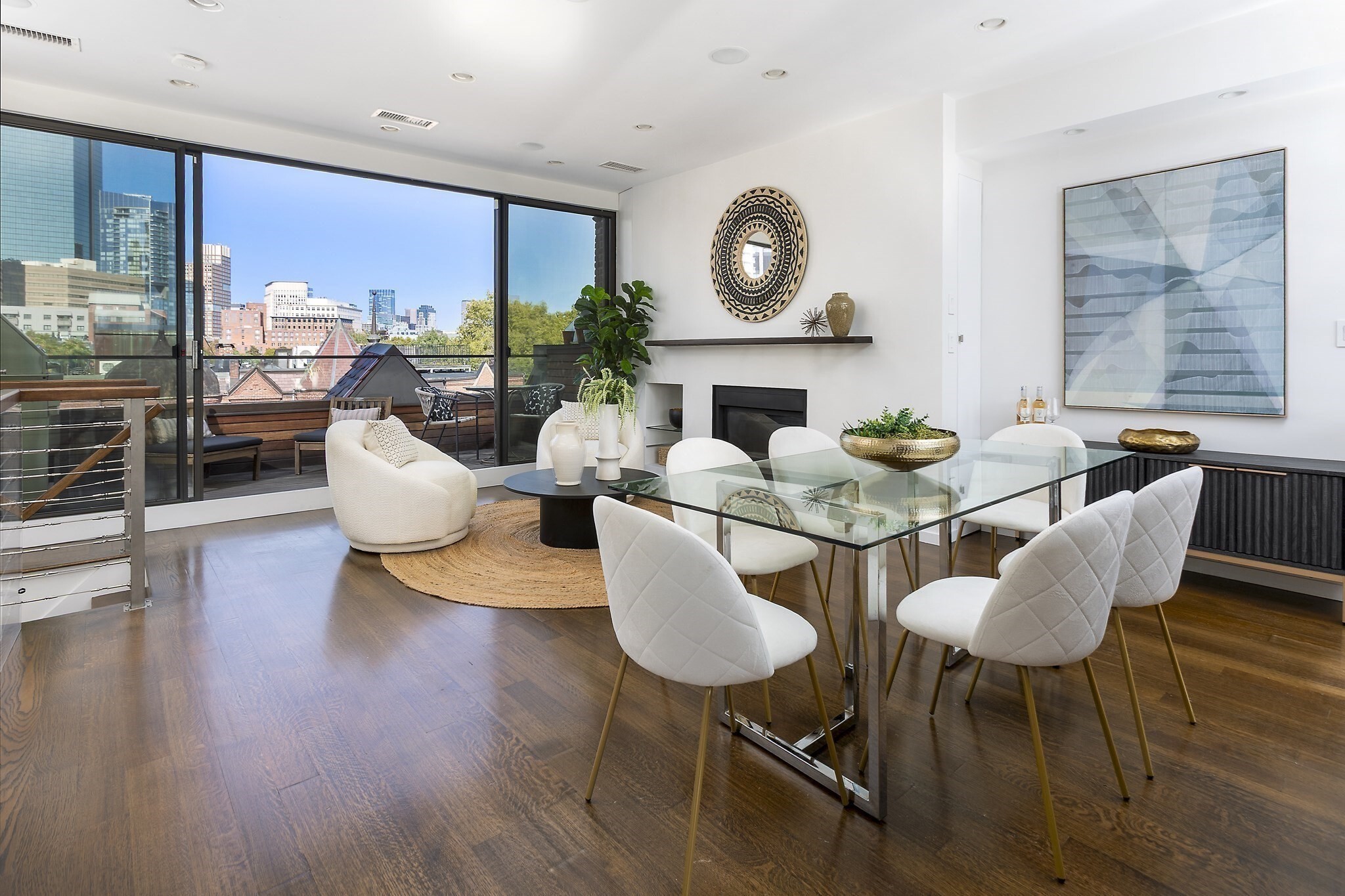 Spectacular South End penthouse triplex 4+ bed with private outdoor space and onsite garage parking! This one of a kind home offers an ideal location along the Southwest Corridor park and a short walk to the Prudential center and an easy walk to all of the South End. Fully renovated 4+ bedroom home offers a large and sunny primary suite with a marble bath and a large walk in closet. The bedroom floor also offers two additional full size bedrooms and a shared full bathroom. A Large 3rd floor living room room is ideal for lounging, is flooded with western facing light and hardwood floors, and has access to a 4th bedroom/office with a Murphy bed and another full bath. A sensational penthouse level kitchen/living/dining space has unmatched wow factor with its oversized sliding glass doors that open to a front facing deck with commanding city skyline views! This real Chef's kitchen offers top-of-the-line appliances, stainless counters, gas cooking, wine storage & is ideal for entertaining! The top floor is flooded with natural light, has a gas fireplace, a half bath and. A large deck allows for seamless indoor/outdoor living and a fixed gas line for grilling. This amazing home is complete in unit laundry, ample storage throughout, central air and 1 full oversized garage space!
