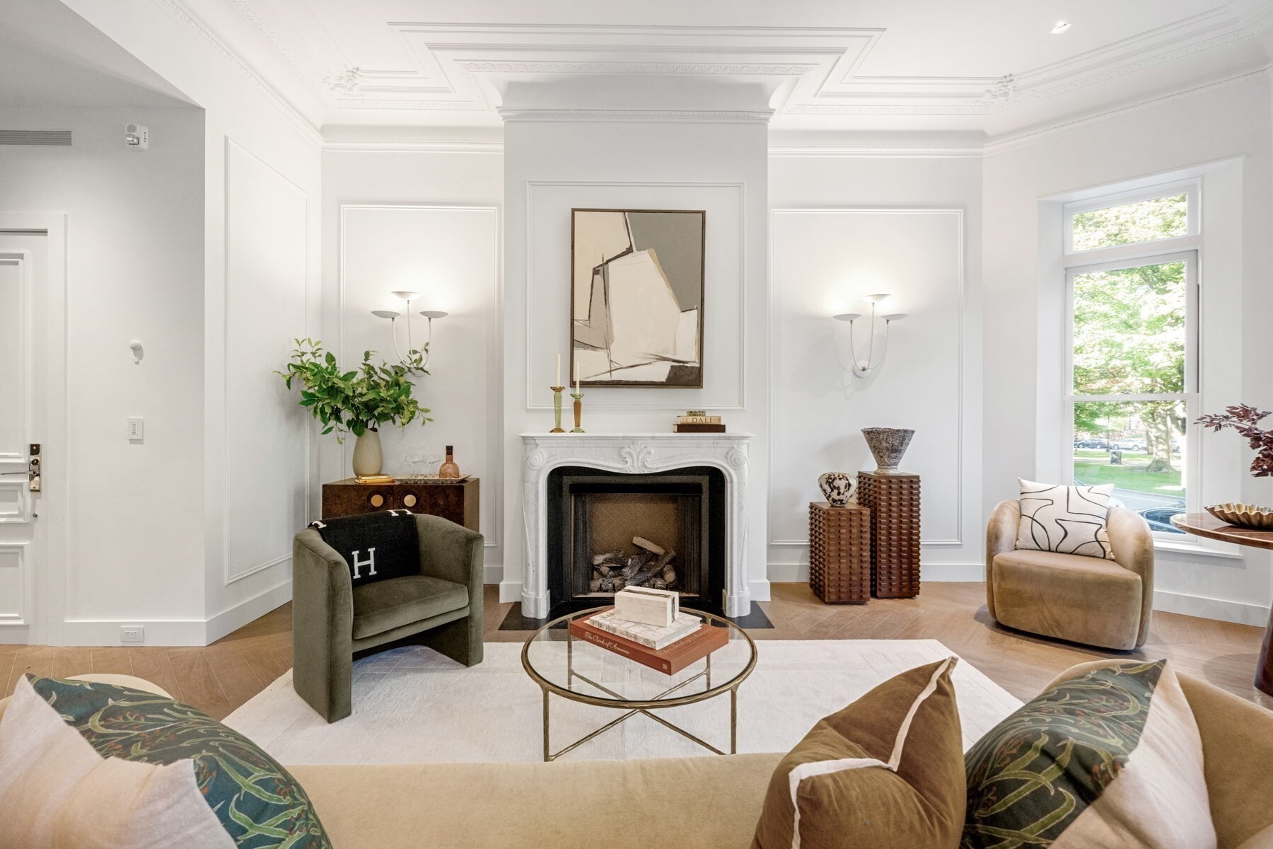 Welcome to Maison Commonwealth, Boston’s newest premier concierge boutique where European elegance meets the historic charm of Back Bay. This remarkable 3 bedroom plus interior study/family room, 3.5 bath Parlor/Garden townhome offers over 2,400 sq. ft. of refined living, two private outdoor retreats, soaring near 12-ft ceilings, intricate plaster moldings, imported hand carved marble fireplaces, cabinetry, wide plank oak floors, all from Italy. The parlor level showcases elegant entertaining spaces overlooking tree-lined Commonwealth Avenue.The primary Bedroom suite w direct access to a private terrace. A spacious family room located off the two Bedroom suite, one opening to a large private brick patio. Floor-to-ceiling stone tiled baths, sleek Italian kitchens with Wolf & Sub-Zero appliances, subzero wine fridge, built in coffee maker,  Concierge service, direct access to 1 heated garage parking, and private storage complete this rare offering. 5 unit condo association, prof managed.