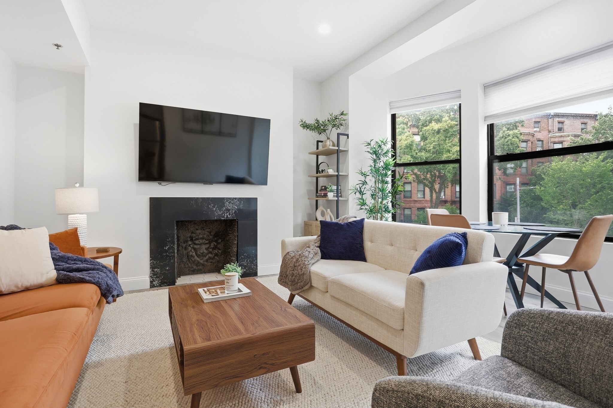 This is not simply renovated, it was completely rebuilt from the studs out. Fully turnkey condo set in The Belvoir in the heart of Kenmore Square, this beautifully finished 2 bedroom residence offers the rare combination of classic Boston character and an essentially new interior. The entire home was gut rebuilt, including new drywall and new interior finishes, creating a fresh, cohesive space designed for effortless city living. Offered furnished and truly turnkey, Unit 206 is ready to enjoy from day one, bring your suitcase. The bright living room is framed by a distinctive bay window, tray ceiling, recessed lighting and a charming decorative fireplace, while the dedicated dining area gives the floor plan a sense of space and separation rarely found in a city condominium of this size. The redesigned kitchen is crisp and contemporary, with stone countertops, stainless steel appliances and a clean, timeless aesthetic. Both bedrooms are thoughtfully proportioned, and the completely remodeled bath continues the same polished finish throughout the home.Central air with individual controls adds everyday comfort, while elevator access and laundry in the building make city living easy. Charles River views and locale provide an added connection to the setting. And the location is exceptional: head outside and Kenmore Station is virtually at your door, with the Charles River Esplanade, Back Bay, Boston University, Fenway Park, restaurants, shopping and some of Boston’s most recognizable destinations all within easy reach.Historic Boston outside. Completely rebuilt, furnished and move-in ready inside. Whether used as a city residence, pied-à-terre or turnkey Boston home, this is an opportunity to skip the renovations, skip the furnishing process and simply arrive.
