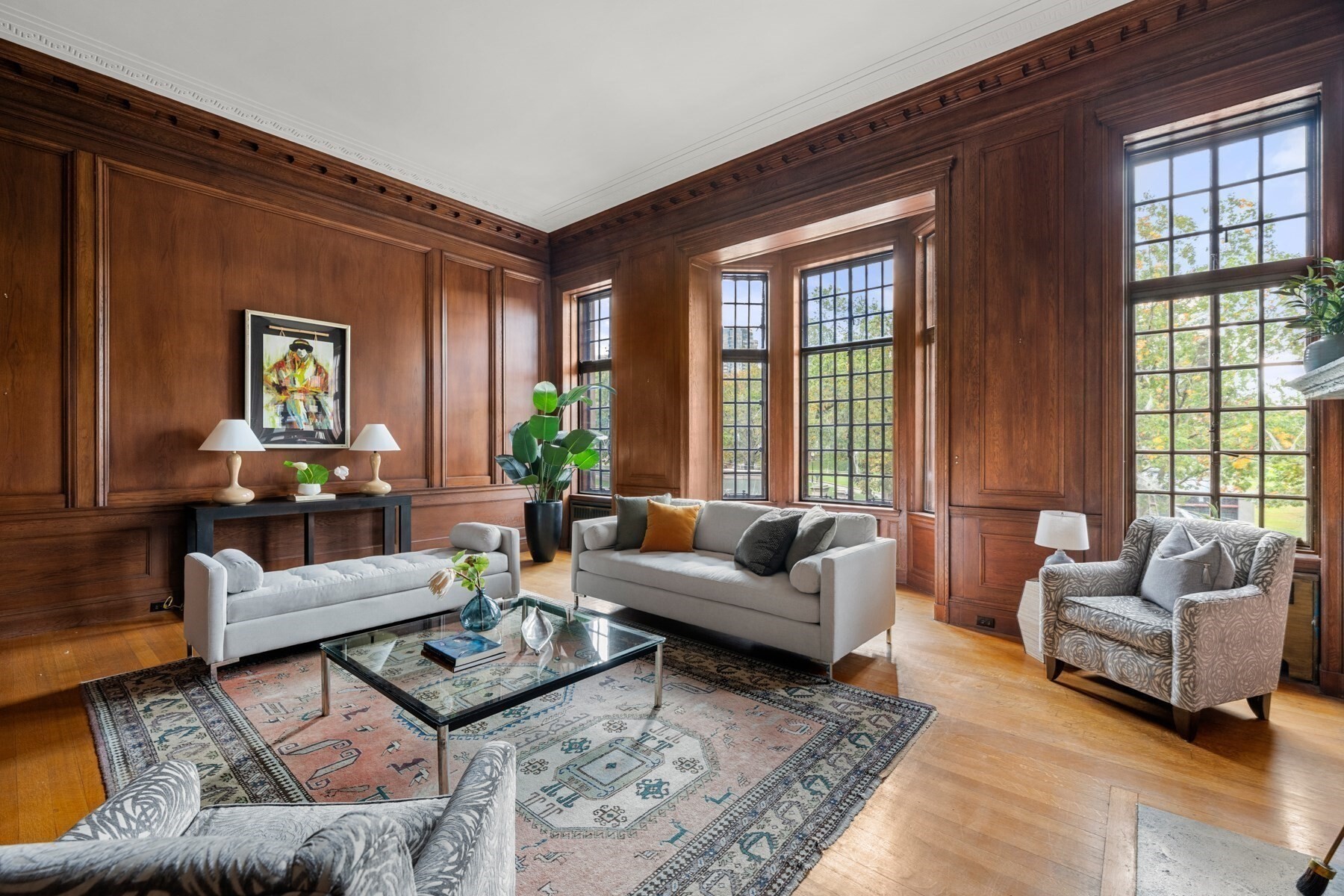 Experience timeless Beacon Hill elegance in this opulent 3+ bedroom duplex overlooking the historic Boston Common. Offering storybook views and greenery, this majestic parlor-level and upper-floor residence features 13-foot ceilings, a dramatic staircase, incredible volume and exceptional, handsome fireplaces. The grand entry foyer is magnificent and leads to a sophisticated, walnut paneled living room with multiple outstanding lead-paned windows, wainscoting and moulding. The dining room is regal with custom cabinetry, this space is truly memorable for entertaining. A large eat-in kitchen is situated nearby. The sun-drenched primary suite features a bow window and more outstanding views and abundant storage. Two addt’l bedrooms, plus a third study, offer flexible living. Additional highlights include direct elevator access & private storage, and a common gym & shared courtyard. This home embodies historic grandeur and sophisticated city living, all at a truly iconic Boston location.